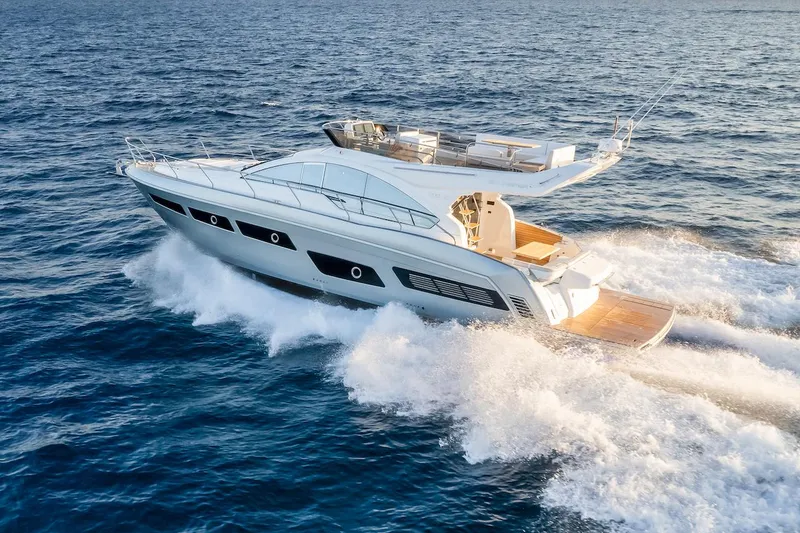 The Image of 2025 Schaefer 510 GT yacht cruising on open sea, showcasing sleek design and luxury. - 0