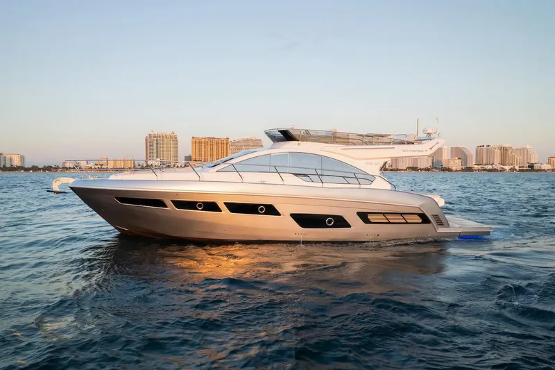 Slide: The Image of 2025 Schaefer 510 GT yacht cruising on open water at sunset. - 1