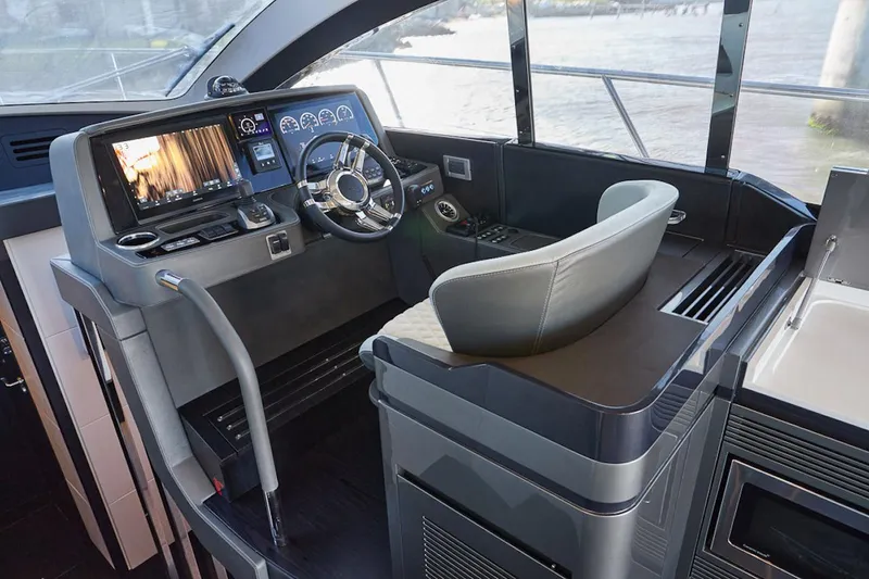 Slide: The Image of Interior cockpit of 2025 Schaefer 510 GT yacht with modern controls and steering wheel. - 16