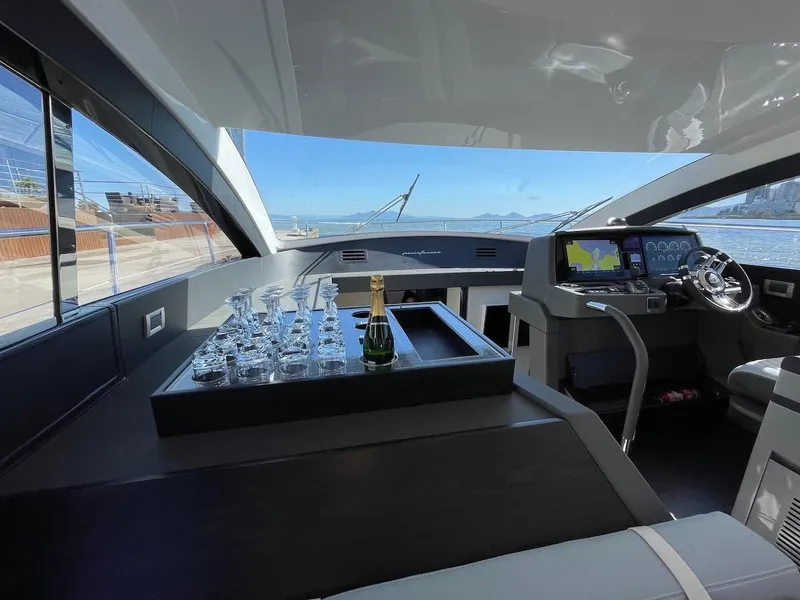Slide: The Image of Interior of 2025 Schaefer 510 GT yacht with modern helm and glassware display. - 17