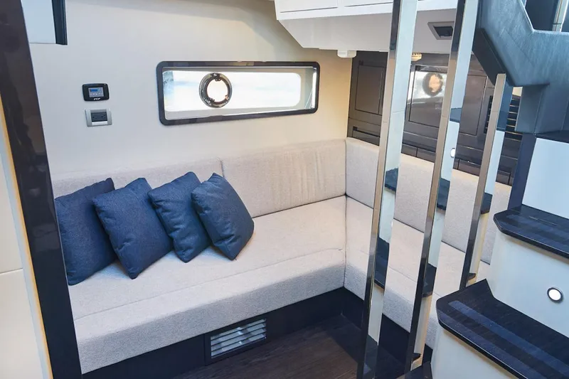 Slide: The Image of Luxurious interior of 2025 Schaefer 510 GT yacht with modern seating and blue cushions. - 19
