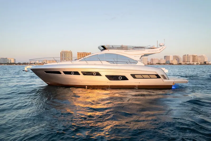 Slide: The Image of 2025 Schaefer 510 GT yacht cruising on calm waters at sunset. - 2