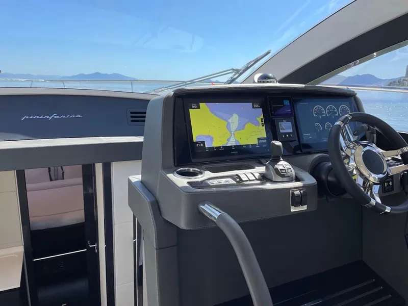 Slide: The Image of Interior view of 2025 Schaefer 510 GT yacht cockpit with navigation screens and steering wheel. - 29
