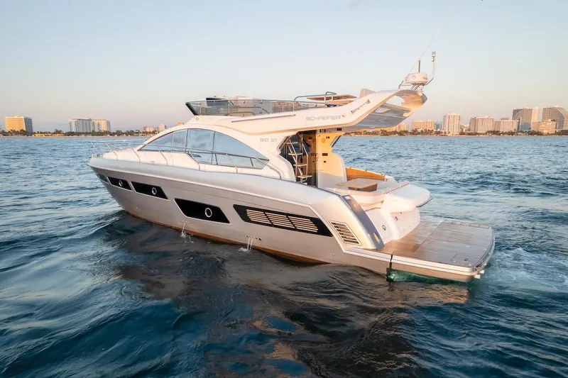 Slide: The Image of 2025 Schaefer 510 GT yacht cruising on open water near city skyline. - 3