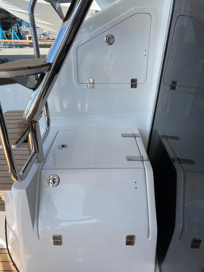 Slide: The Image of 2025 Schaefer 510 GT yacht deck with sleek white storage compartments. - 32