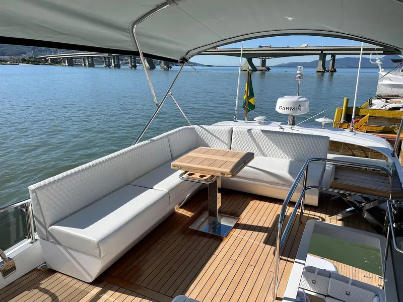 Slide: The Image of Luxurious 2025 Schaefer 510 GT yacht deck with elegant seating and wooden table. - 38