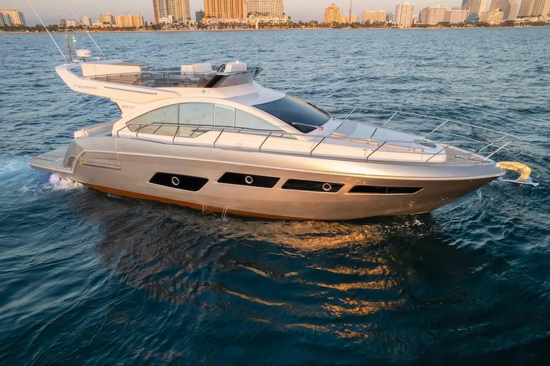 Slide: The Image of 2025 Schaefer 510 GT yacht cruising on ocean near city skyline. - 7