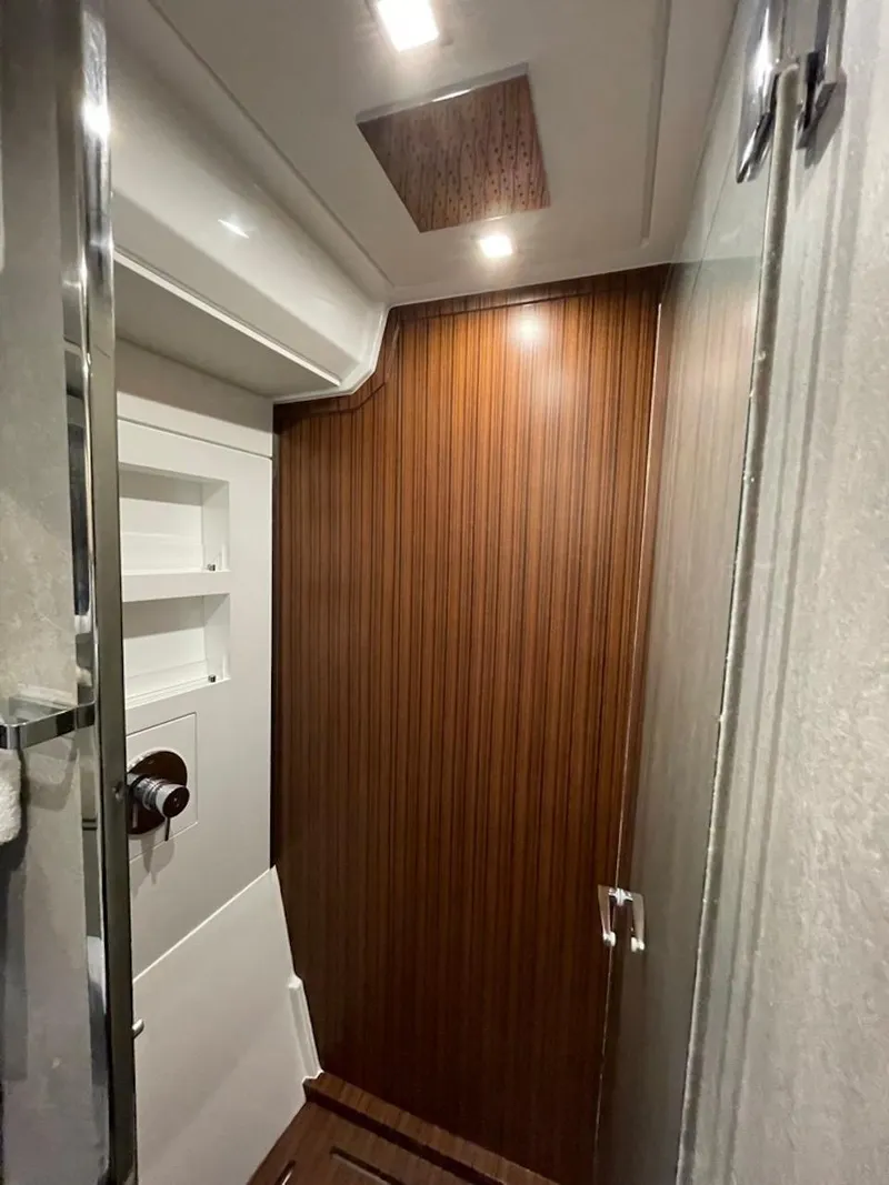 Slide: The Image of Interior of 2025 Schaefer 510 GT yacht, featuring sleek wood paneling and modern lighting. - 28