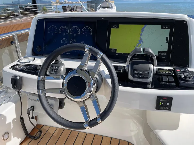 Slide: The Image of Steering console of 2025 Schaefer 510 GT yacht with navigation displays and controls. - 41