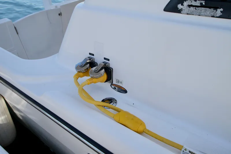 Slide: The Image of 2002 Bayliner 3988 Command Bridge Motoryacht with yellow shore power cables connected. - 10