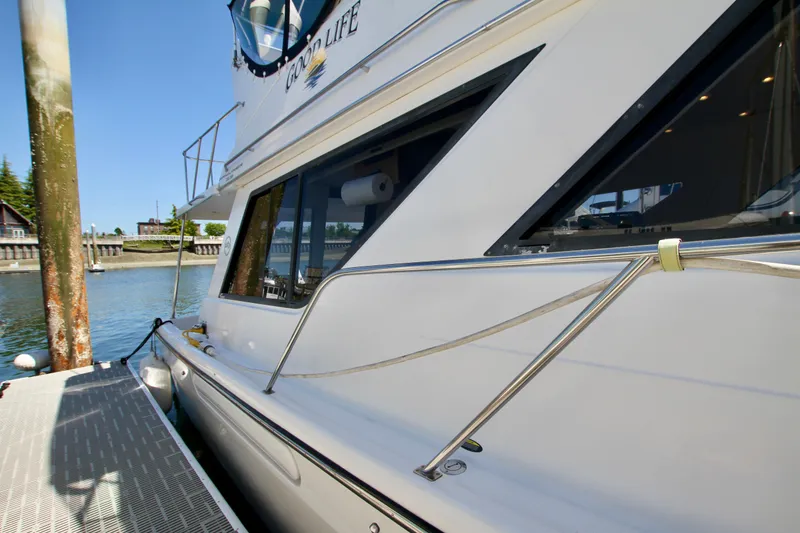 Slide: The Image of 2002 Bayliner 3988 Command Bridge Motoryacht docked at marina, side view. - 12