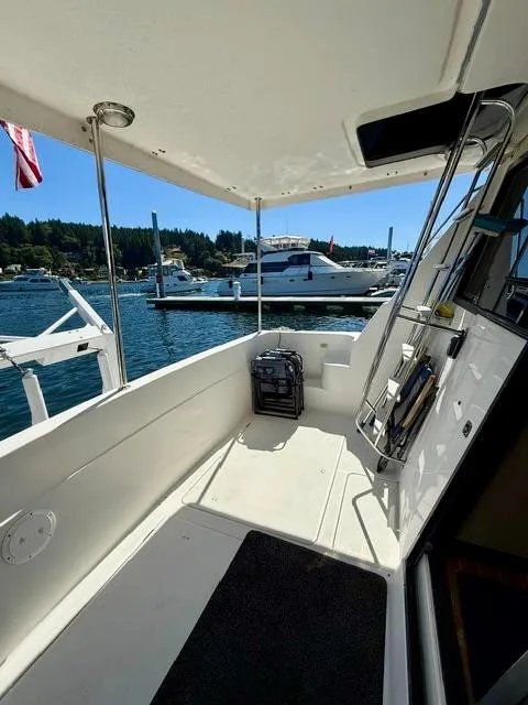 Slide: The Image of 2002 Bayliner 3988 Command Bridge Motoryacht docked at a scenic marina. - 18