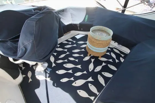 Slide: The Image of 2002 Bayliner 3988 Command Bridge Motoryacht interior with fish-patterned rug and wicker basket. - 20
