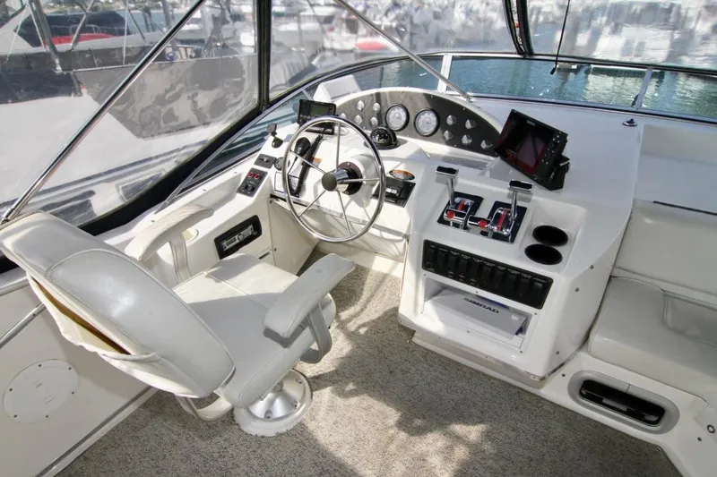 Slide: The Image of 2002 Bayliner 3988 Command Bridge Motoryacht helm with steering wheel and control panel. - 23