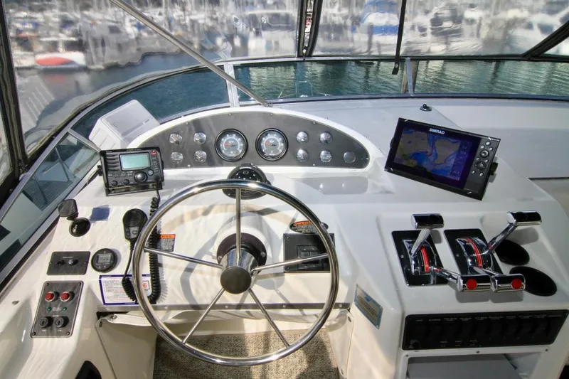 Slide: The Image of Helm of 2002 Bayliner 3988 Command Bridge Motoryacht with navigation equipment and steering wheel. - 24