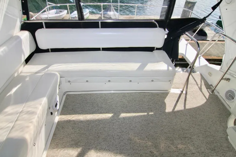 Slide: The Image of 2002 Bayliner 3988 Command Bridge Motoryacht interior with white seating and carpeted floor. - 28