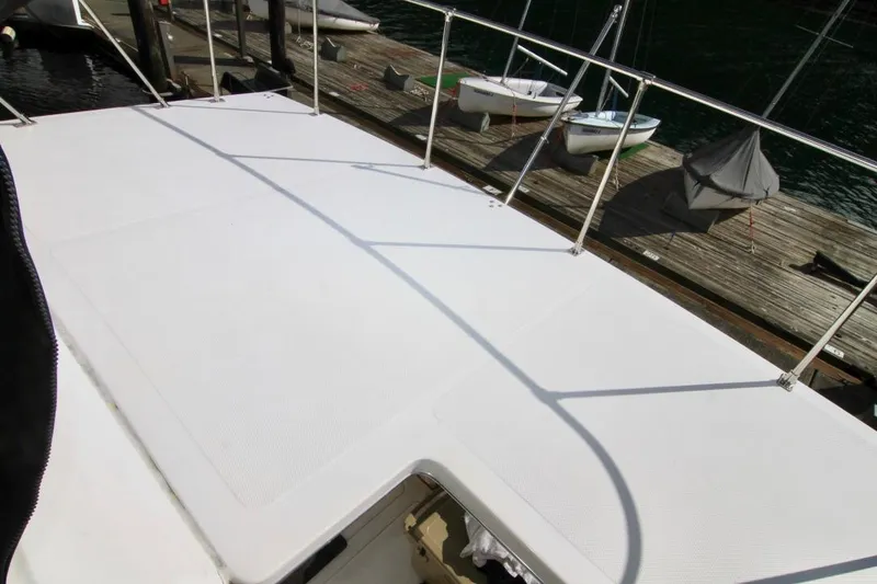 Slide: The Image of 2002 Bayliner 3988 Command Bridge Motoryacht deck, docked with boats in the background. - 29