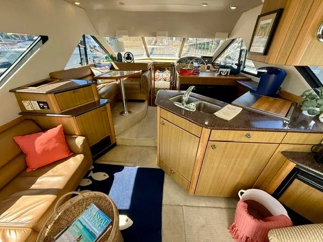 Slide: The Image of Luxurious interior of 2002 Bayliner 3988 Command Bridge Motoryacht with modern kitchen and seating area. - 34