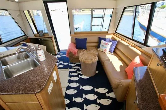 Slide: The Image of Interior of 2002 Bayliner 3988 Command Bridge Motoryacht with cozy seating and nautical decor. - 40
