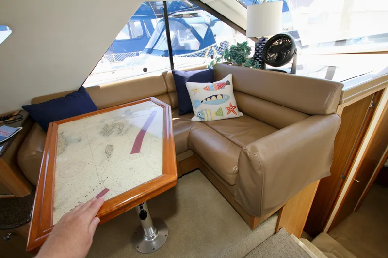 Slide: The Image of Interior of 2002 Bayliner 3988 Command Bridge Motoryacht with cozy seating and nautical decor. - 43