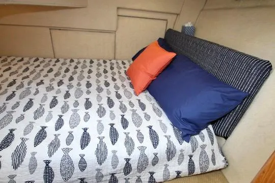 Slide: The Image of Cozy bedroom in 2002 Bayliner 3988 Command Bridge Motoryacht with fish-patterned bedding and colorful pillows. - 55