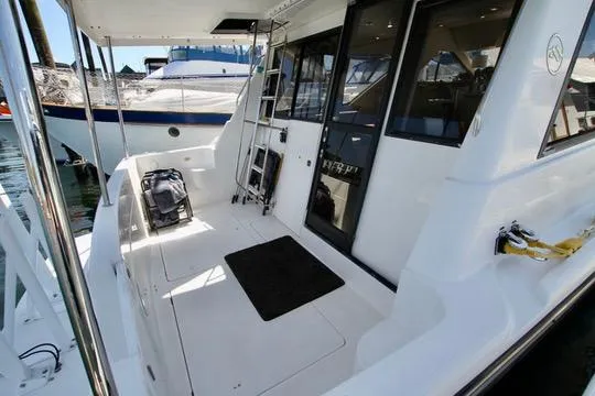 Slide: The Image of 2002 Bayliner 3988 Command Bridge Motoryacht deck with ladder and seating area. - 8