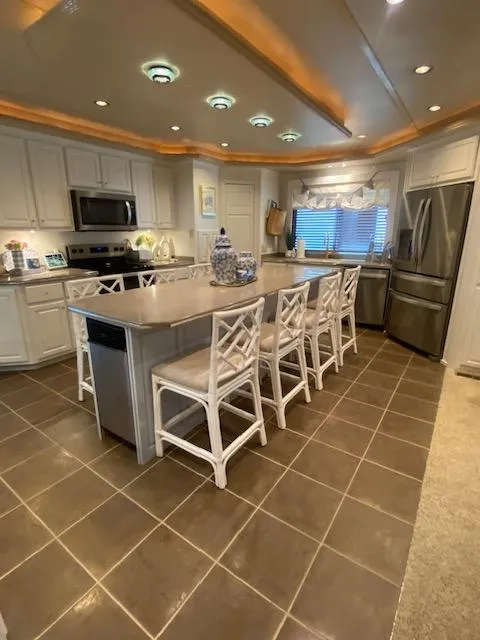 Slide: The Image of Spacious kitchen in a 2006 Fantasy Houseboat with modern appliances and island seating. - 10