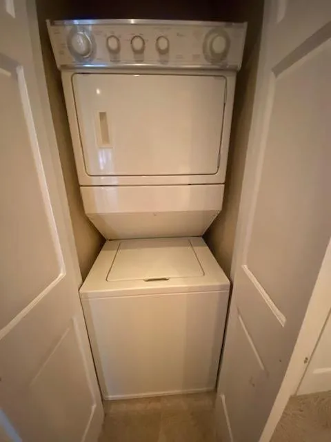 Slide: The Image of Stacked washer and dryer in a compact laundry closet on a 2006 Fantasy Houseboat. - 13