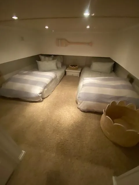 Slide: The Image of Cozy twin bedroom in a 2006 Fantasy houseboat with soft lighting and nautical decor. - 20