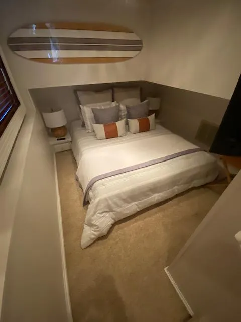 Slide: The Image of Cozy bedroom in 2006 Fantasy houseboat with modern decor and surfboard wall art. - 21