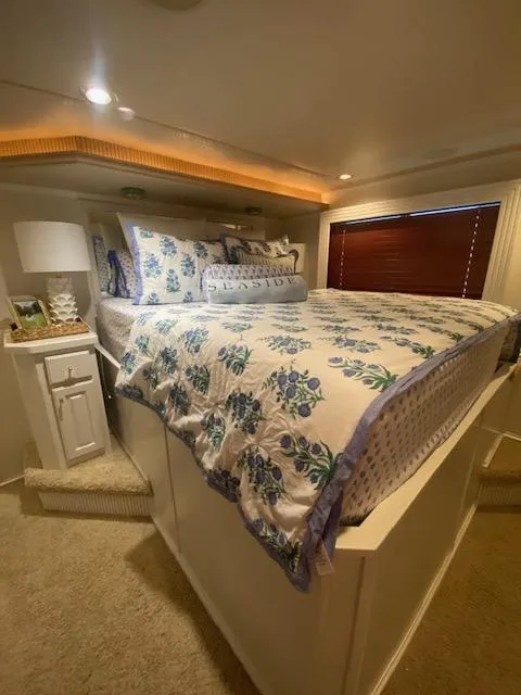 Slide: The Image of Cozy bedroom in a 2006 Fantasy houseboat with floral bedding and ambient lighting. - 23