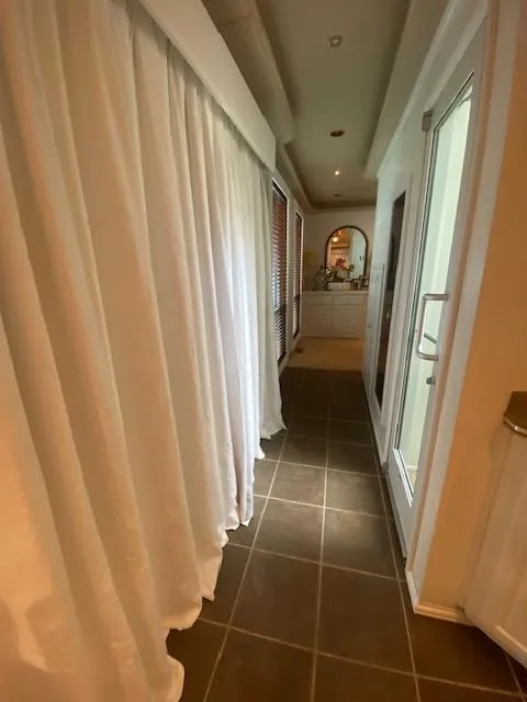 Slide: The Image of Narrow hallway in a 2006 Fantasy houseboat with tiled floor and white curtains. - 28