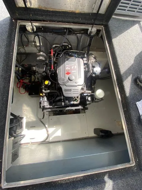 Slide: The Image of Engine compartment of a 2006 Fantasy Houseboat, showcasing a well-maintained motor. - 37