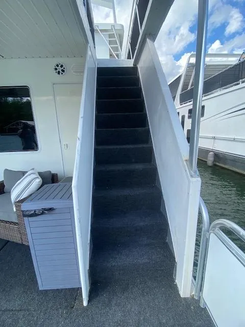 Slide: The Image of Staircase on a 2006 Fantasy houseboat, leading to upper deck, with outdoor seating nearby. - 40