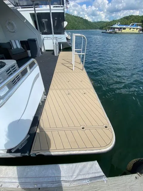 Slide: The Image of Modern 2006 Fantasy houseboat docked on a serene lake with scenic views. - 41