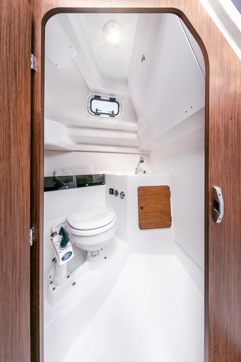 Slide: The Image of 2023 Beneteau Antares 8 boat interior bathroom with modern fixtures and wooden accents. - 15