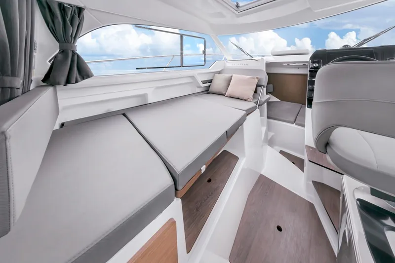 Slide: The Image of Interior of 2023 Beneteau Antares 8 boat, featuring modern seating and sleek design. - 17