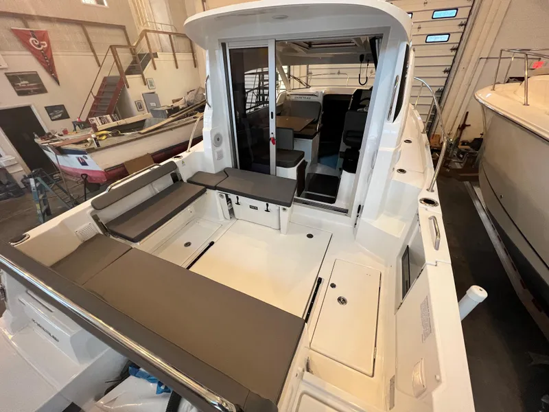 Slide: The Image of 2023 Beneteau Antares 8 boat interior with seating and storage compartments. - 19