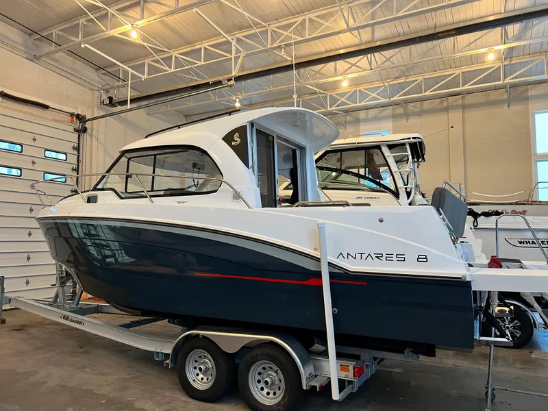 Slide: The Image of 2023 Beneteau Antares 8 boat on a trailer in a warehouse. - 2