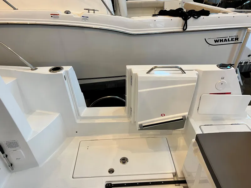 Slide: The Image of 2023 Beneteau Antares 8 boat deck with storage compartments and seating. - 21