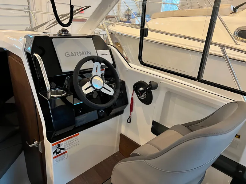 Slide: The Image of 2023 Beneteau Antares 8 cockpit with Garmin navigation system and comfortable seating. - 24