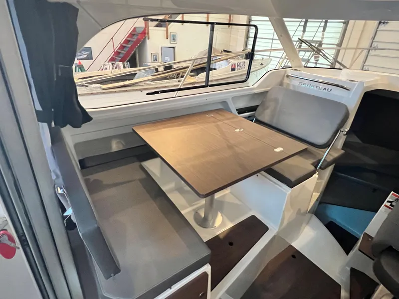 Slide: The Image of Interior seating area of 2023 Beneteau Antares 8 with table and cushioned benches. - 25