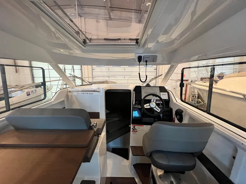 Slide: The Image of Interior of 2023 Beneteau Antares 8 boat with steering console and seating. - 27