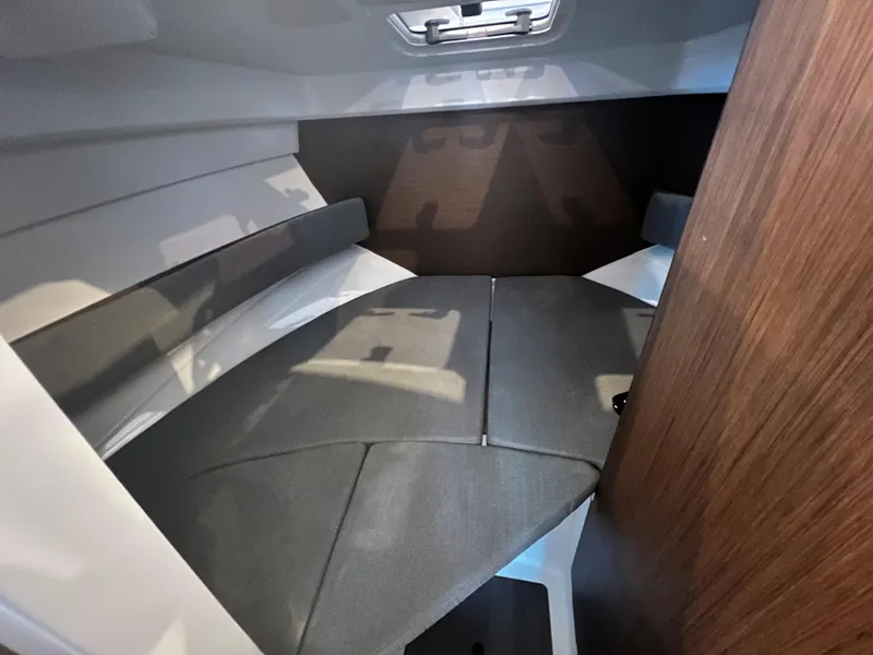 Slide: The Image of 2023 Beneteau Antares 8 cabin interior with cushioned seating and wooden accents. - 28