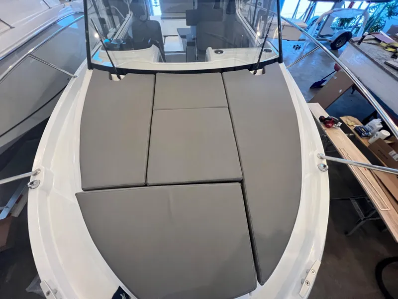 Slide: The Image of 2023 Beneteau Antares 8 boat with cushioned bow seating area. - 30