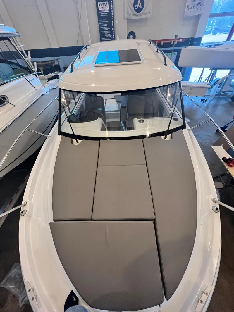 Slide: The Image of 2023 Beneteau Antares 8 boat with cushioned deck, displayed indoors. - 32