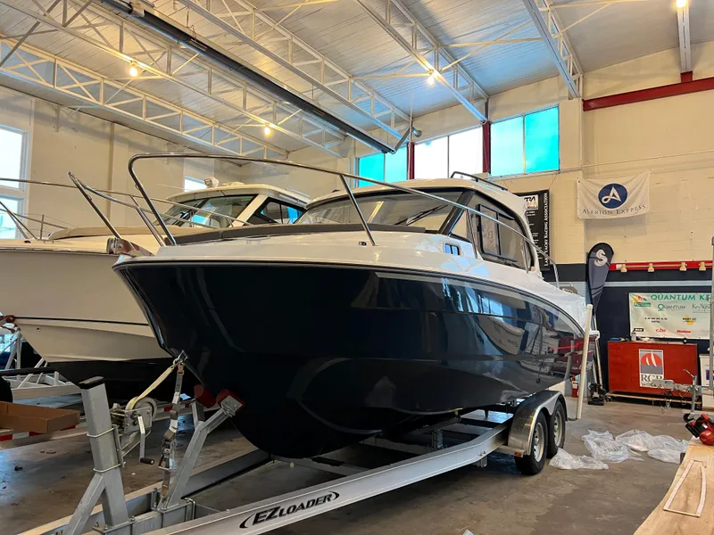 Slide: The Image of 2023 Beneteau Antares 8 boat on trailer in indoor showroom. - 4