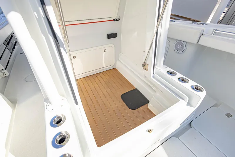 Slide: The Image of 2015 Yellowfin 32 Offshore boat interior with teak flooring and rod holders. - 10