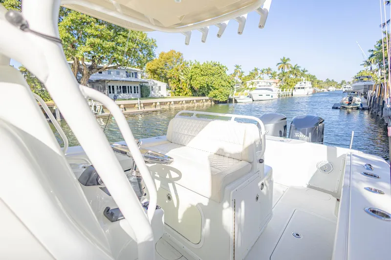 Slide: The Image of 2015 Yellowfin 32 Offshore boat on a sunny canal with lush greenery. - 17