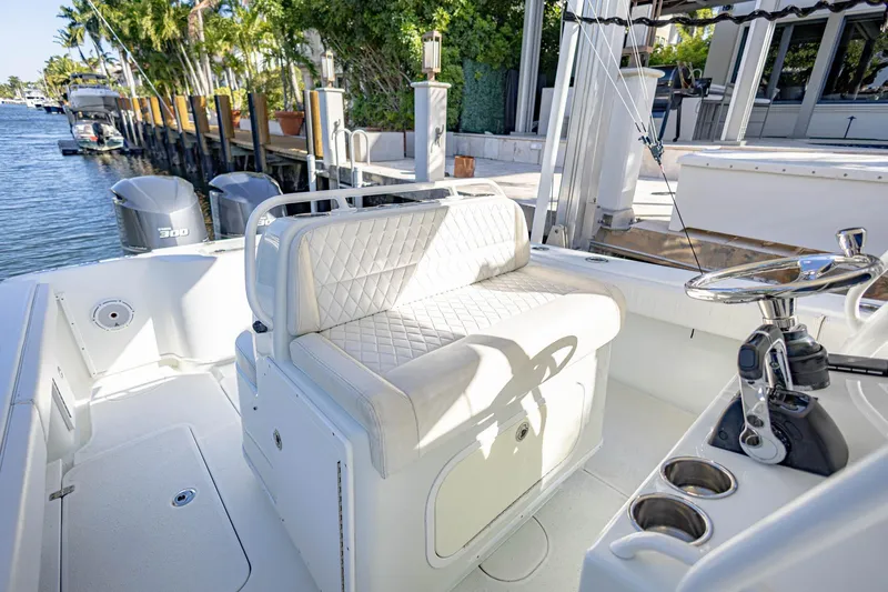 Slide: The Image of 2015 Yellowfin 32 Offshore boat interior with seating and steering wheel. - 18